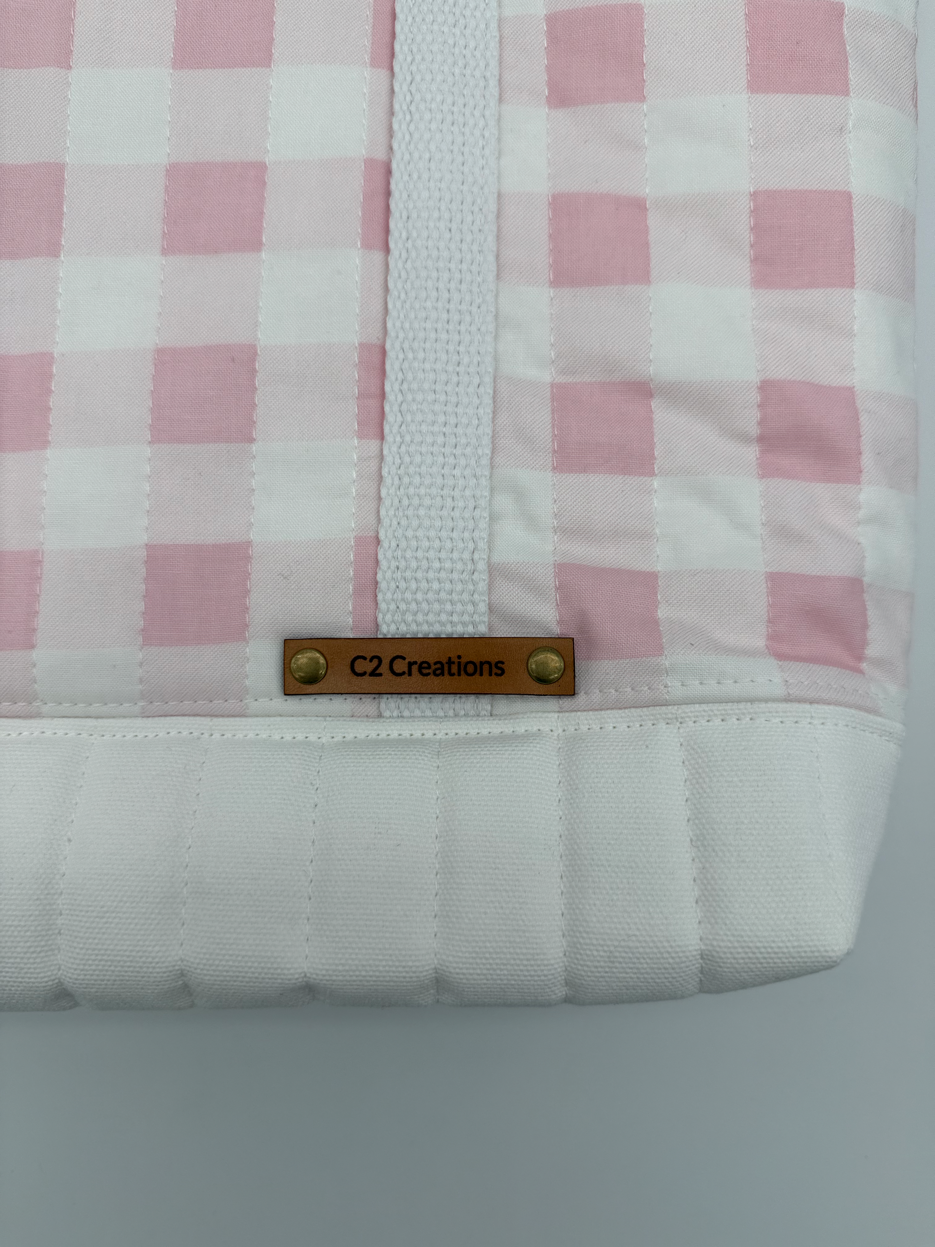 Close up of pink gingham quilted tote bag fabric